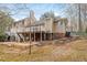 Two-story home featuring a large deck with white railings and stairs to the yard at 7825 Breckon Way, Raleigh, NC 27615