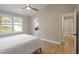 Serene bedroom with vaulted ceiling, vinyl floors, and a doorway to an ensuite bathroom at 7825 Breckon Way, Raleigh, NC 27615