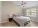 Comfortable bedroom with vaulted ceiling, ceiling fan, and a large window allowing for plenty of natural light at 7825 Breckon Way, Raleigh, NC 27615