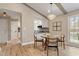 Charming dining area with view to the kitchen, featuring a glass table, stylish chairs, and neutral decor at 7825 Breckon Way, Raleigh, NC 27615