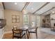 Inviting dining area featuring a glass table, stylish chairs, and natural light from the adjacent deck access at 7825 Breckon Way, Raleigh, NC 27615
