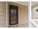 View of front door with hanging flower basket and gold porch light at 7825 Breckon Way, Raleigh, NC 27615