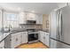 Modern kitchen showcasing stainless steel appliances, black countertops, and white cabinetry at 7825 Breckon Way, Raleigh, NC 27615