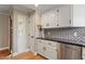 Stylish kitchen featuring black countertops, stainless steel appliances, and ample cabinet space at 7825 Breckon Way, Raleigh, NC 27615