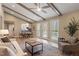 Open-concept living area with wood beams, fireplace, and access to the outdoors through french doors at 7825 Breckon Way, Raleigh, NC 27615