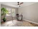 Bright office with streamlined desk, ceiling fan, neutral tones, and large window for optimal light at 7825 Breckon Way, Raleigh, NC 27615