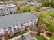 This aerial view shows a well-maintained building with balconies, landscaping, parking, and community walkways at 800 Moratuck Dr # 108, Raleigh, NC 27604