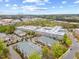 This community aerial showcases multiple buildings, mature trees, parking, and a glimpse of the city skyline at 800 Moratuck Dr # 108, Raleigh, NC 27604