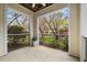 Relaxing covered balcony with views of the serene landscaped surroundings at 800 Moratuck Dr # 108, Raleigh, NC 27604