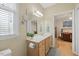 Bathroom with single sink, vanity with plant and view to bedroom at 800 Moratuck Dr # 108, Raleigh, NC 27604