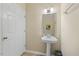 Simple powder room with pedestal sink and modern fixtures at 800 Moratuck Dr # 108, Raleigh, NC 27604