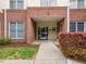 Exterior building entrance features brick accents, a well-lit entryway, and manicured landscaping in a vibrant community at 800 Moratuck Dr # 108, Raleigh, NC 27604
