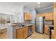 Open kitchen layout with stainless appliances, breakfast bar, and views into the living area at 800 Moratuck Dr # 108, Raleigh, NC 27604