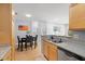 Eat-in kitchen with granite countertops, stainless appliances, and open view to the dining area at 800 Moratuck Dr # 108, Raleigh, NC 27604