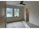 Bedroom with hardwood floors, two windows, and a modern ceiling fan at 801 N Elm St, Durham, NC 27701