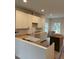 Bright kitchen space with white cabinets and modern farmhouse sink at 801 N Elm St, Durham, NC 27701
