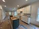 Open concept kitchen with bright white cabinets at 801 N Elm St, Durham, NC 27701