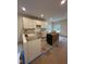 Bright kitchen space with white cabinets, sink, and modern lighting at 801 N Elm St, Durham, NC 27701