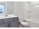 Clean bathroom with a white vanity, white toilet, and combination shower and tub at 804 Windmill Palm Dr, Zebulon, NC 27597