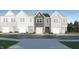 Charming townhome featuring a stone-accented garage and a welcoming front entrance at 804 Windmill Palm Dr, Zebulon, NC 27597