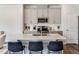 Bright kitchen featuring modern gray cabinets, stainless steel appliances, and a center island with seating at 804 Windmill Palm Dr, Zebulon, NC 27597