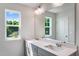 Bathroom with double sink vanity, large mirror, and natural light at 812 Windmill Palm Dr, Zebulon, NC 27597
