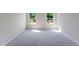 Bedroom featuring carpet flooring, neutral paint, and two windows at 812 Windmill Palm Dr, Zebulon, NC 27597