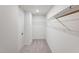 Walk-in closet features carpet flooring and a wire shelving unit at 812 Windmill Palm Dr, Zebulon, NC 27597