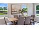 Elegant dining room features a modern table setting with seating for six, complemented by natural light and stylish decor at 812 Windmill Palm Dr, Zebulon, NC 27597