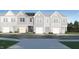Charming townhome showcases a light blue exterior, complemented by a private garage for convenient parking and additional storage at 812 Windmill Palm Dr, Zebulon, NC 27597