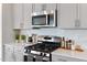 Kitchen featuring stainless steel appliances, tile backsplash, and gray cabinets at 812 Windmill Palm Dr, Zebulon, NC 27597