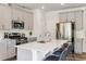 Stylish kitchen with a large island, stainless steel appliances, and elegant countertops, perfect for cooking and entertaining at 812 Windmill Palm Dr, Zebulon, NC 27597