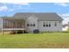Spacious backyard featuring a raised deck, screened in porch, and lush green lawn at 8925 Hopkins Knob Ct, Zebulon, NC 27597