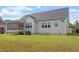 Grassy backyard with raised deck and screened in porch, offering ample space for outdoor activities at 8925 Hopkins Knob Ct, Zebulon, NC 27597