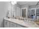 Modern bathroom featuring double sinks with white cabinets and granite countertops at 8925 Hopkins Knob Ct, Zebulon, NC 27597