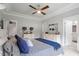Well-lit bedroom showcasing neutral walls, ceiling fan, and access to an en-suite bathroom at 8925 Hopkins Knob Ct, Zebulon, NC 27597
