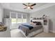 Bright bedroom with a ceiling fan, neutral walls, and a bed with built-in storage and drawers at 8925 Hopkins Knob Ct, Zebulon, NC 27597