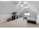 Open bonus room with neutral walls, carpet, ceiling fan and a window that lets in lots of natural light at 8925 Hopkins Knob Ct, Zebulon, NC 27597