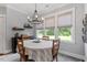 Charming dining room with bright windows, elegant lighting, and comfortable seating for memorable meals at 8925 Hopkins Knob Ct, Zebulon, NC 27597