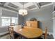 Dining room featuring coffered ceilings, a chandelier, and window view at 8925 Hopkins Knob Ct, Zebulon, NC 27597