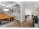 Bright dining area with hardwood floors, coffered ceiling, and elegant lighting fixtures and decor at 8925 Hopkins Knob Ct, Zebulon, NC 27597