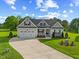 Charming single-Gathering home with a well-manicured lawn, attached two-car garage and inviting front porch at 8925 Hopkins Knob Ct, Zebulon, NC 27597