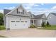 Lovely home with a two-car garage and a welcoming front porch, seamlessly blending comfort and style at 8925 Hopkins Knob Ct, Zebulon, NC 27597