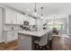 Open kitchen design with large island, stainless appliances, hardwood flooring, and seamless dining room access at 8925 Hopkins Knob Ct, Zebulon, NC 27597