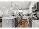 Contemporary kitchen with stainless appliances, a spacious island, and hardwood floors, perfect for culinary enthusiasts at 8925 Hopkins Knob Ct, Zebulon, NC 27597
