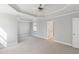 Bright bedroom with neutral paint, tray ceilings, and ensuite bathroom entrance at 912 Sethcreek Dr, Fuquay Varina, NC 27526