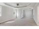 Bright, carpeted bedroom featuring a tray ceiling and neutral paint at 912 Sethcreek Dr, Fuquay Varina, NC 27526