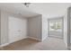 Comfortable carpeted bedroom with a closet and a bright window overlooking the neighborhood at 912 Sethcreek Dr, Fuquay Varina, NC 27526