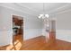Dining room showcasing hardwood floors, wainscotting, and views to the entryway and kitchen at 912 Sethcreek Dr, Fuquay Varina, NC 27526