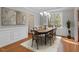 Dining room with large window, hardwood flooring, wainscotting, and decorative light fixture at 912 Sethcreek Dr, Fuquay Varina, NC 27526